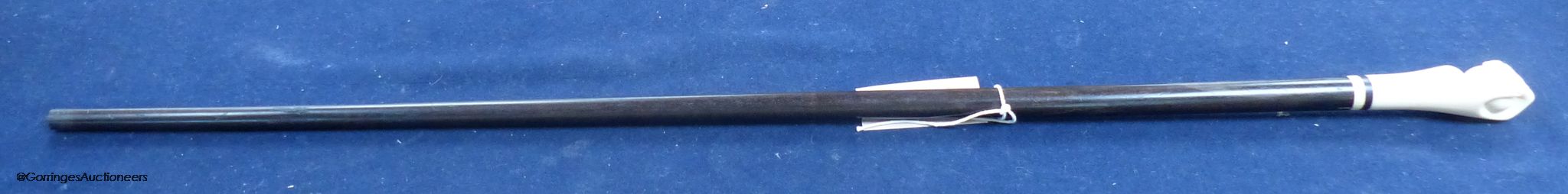 A rosewood and ivory handled walking stick in the form of a hand holding a ball